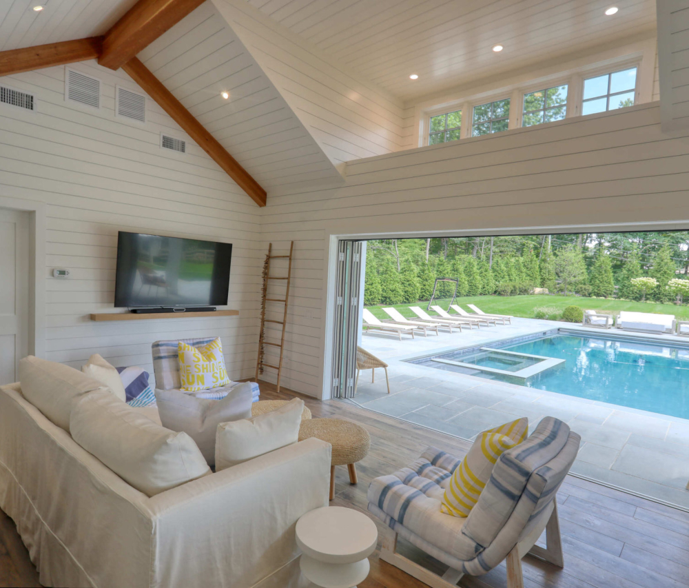 A finished addition by Inferno Construction opening to a backyard pool.