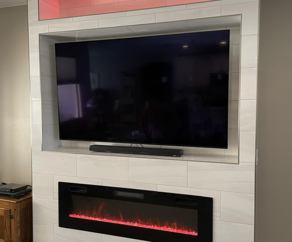 A custom media wall with a linear electric fireplace.